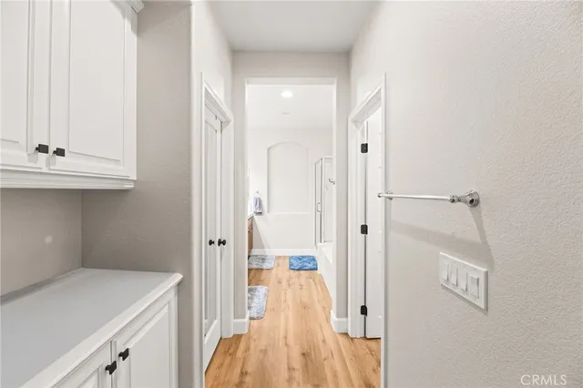 a bathroom with a tub a sink and a large mirror