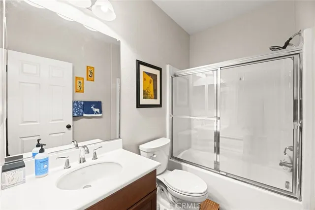 a white toilet sitting next to a bathroom sink