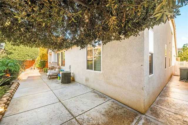 a view of a garden with a chair and table in the patio