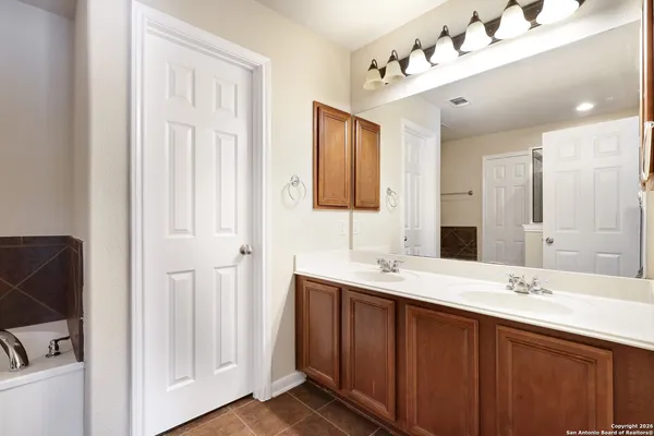 a bathroom with a double vanity sink and mirror