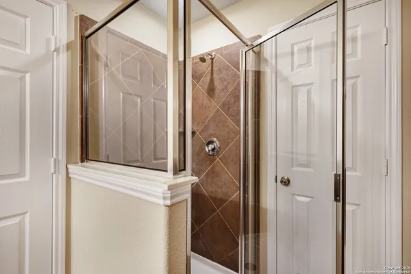 a bathroom that has a glass shower door