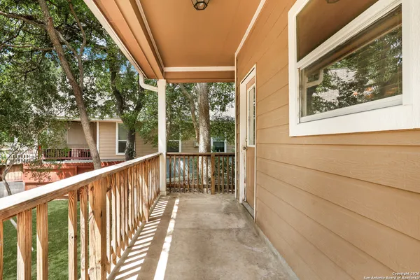 a view of balcony with wooden floor and fence