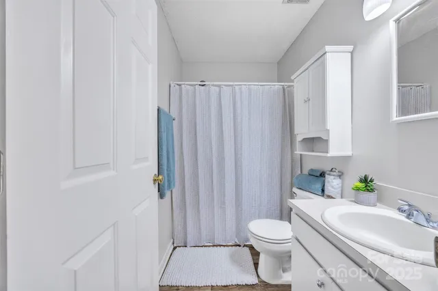 a bathroom with a toilet a sink and a shower