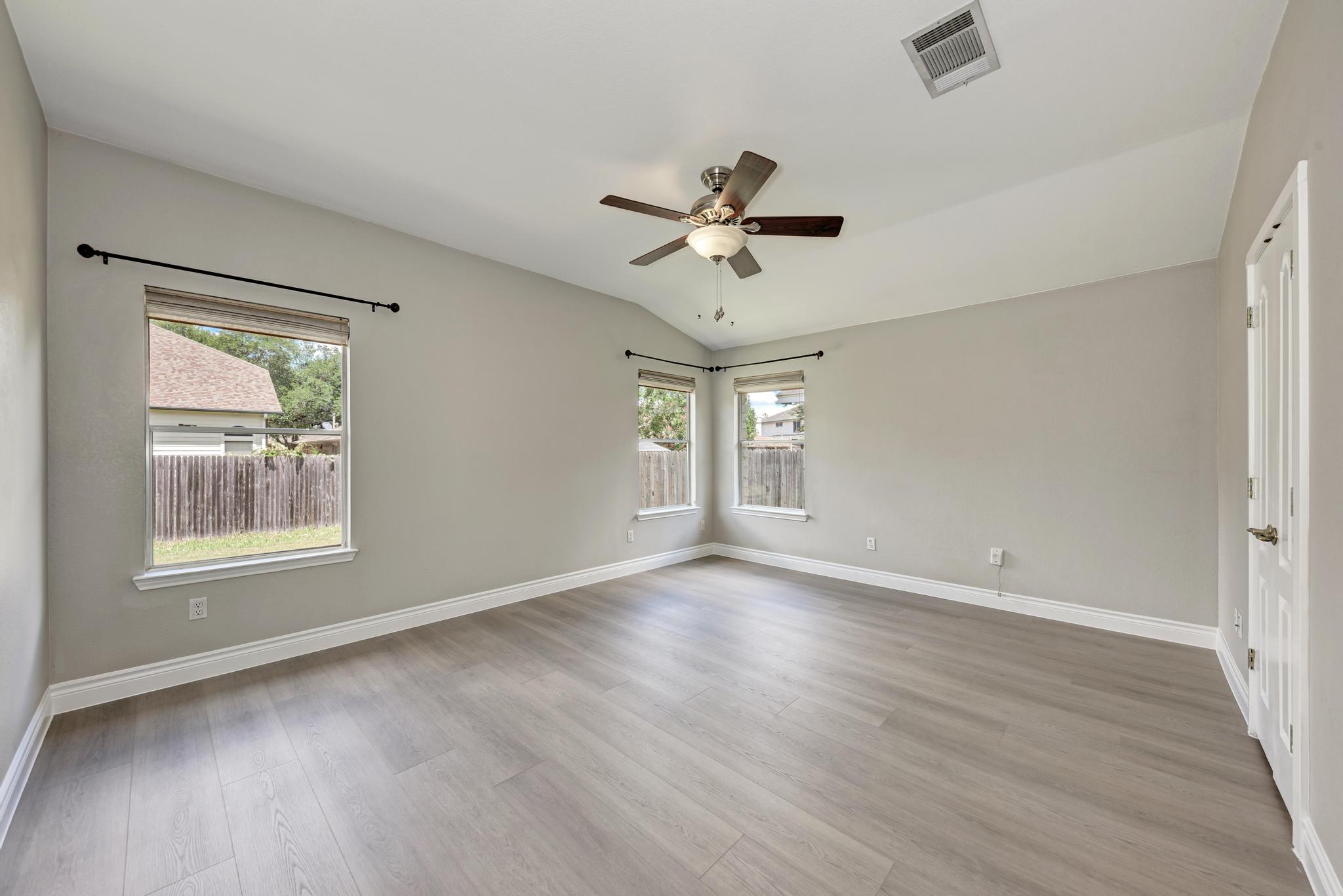 4408 Tello Path Austin, TX 78749 - Photo 20 of 38 Spare room with healthy amount of natural light, a ceiling fan, vaulted ceiling, and light wood-style floors