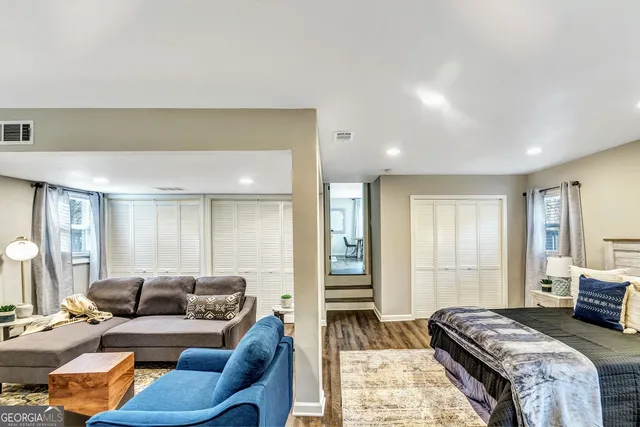 a spacious bedroom with a bed and furniture