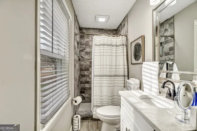 a bathroom with a sink toilet and shower