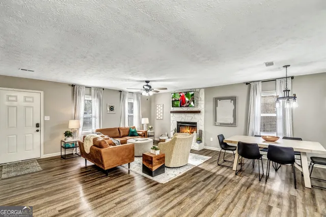 a living room with furniture a fireplace and a table