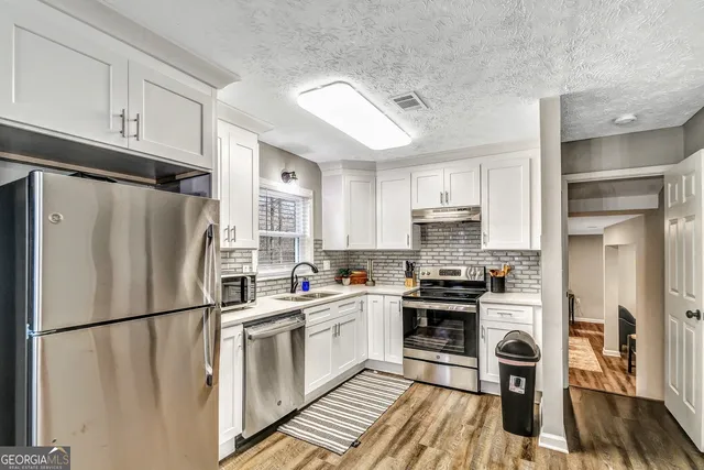 a kitchen with a refrigerator a sink and dishwasher