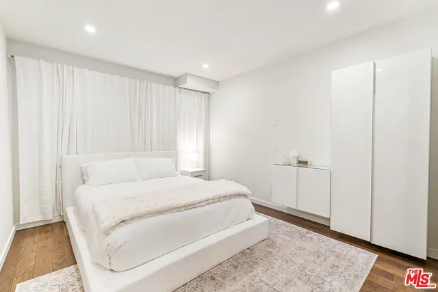 a large white bed in a white room