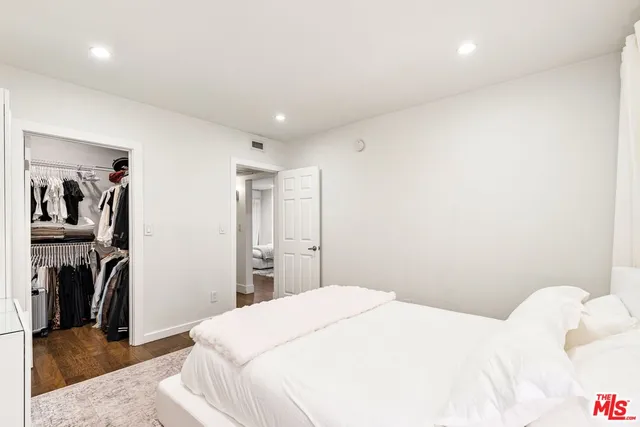 a bedroom with a bed and a television