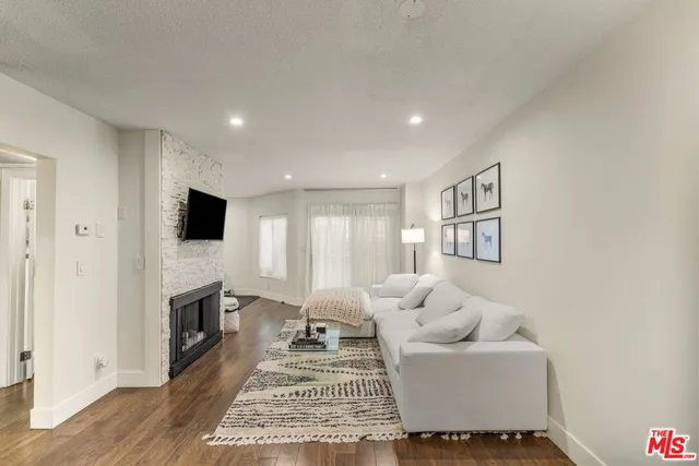 a living room with furniture fireplace and flat screen tv