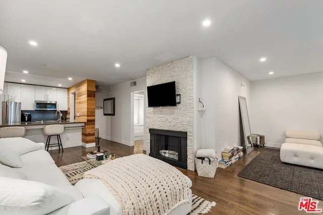 a living room with furniture flat screen tv and a fireplace