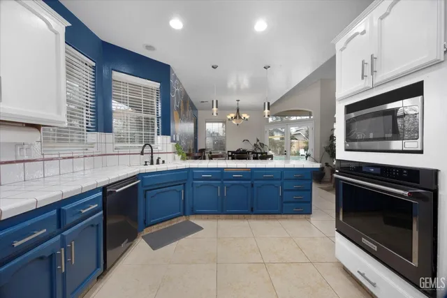 a kitchen with stainless steel appliances granite countertop a sink stove and microwave