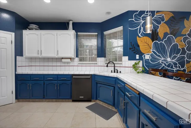 a kitchen with stainless steel appliances granite countertop a sink and a wooden cabinets