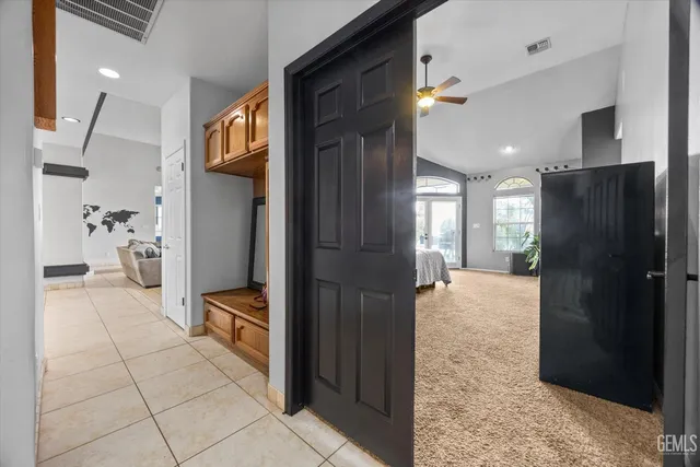 a view of a hallway with wooden floor and a living room