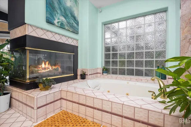 a room with a bed a flat screen tv and a large window