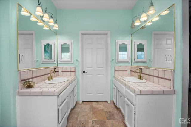 a bathroom with a double vanity sink and a mirror