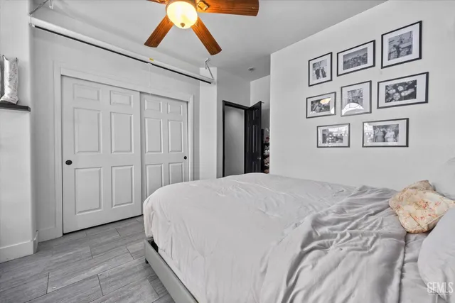 a bedroom with a bed and painting on the wall