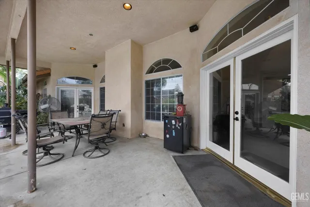 a view of a patio with table and chairs and potted plants