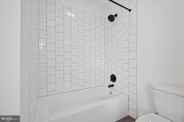 a bathroom with a bathtub and shower