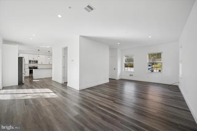 a view of a kitchen with a sink and a refrigerator