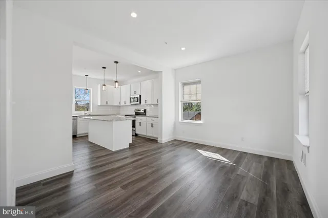 a view of kitchen with wooden floor and electronic appliances