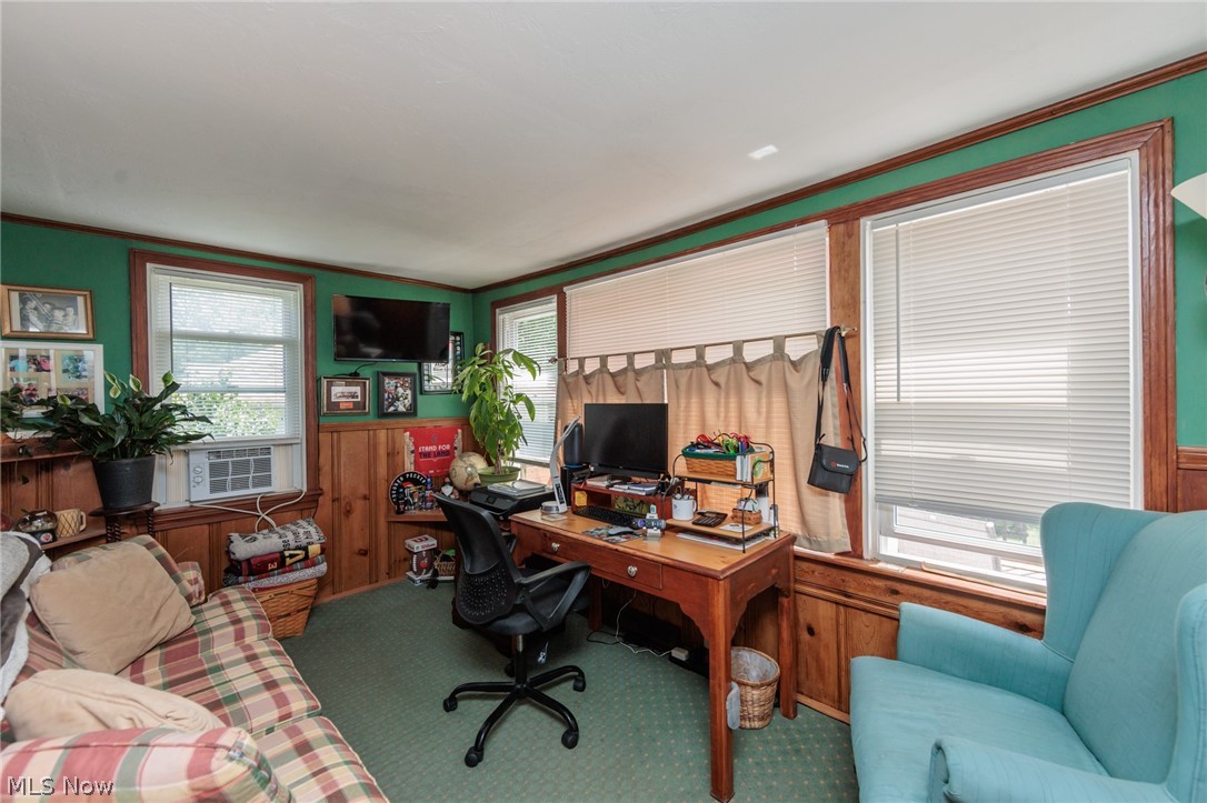 5364 Summit Road Lyndhurst, OH 44124 - Photo 9 of 42 Room featuring wood-paneled wainscoting, green wall paint, and white trim windows