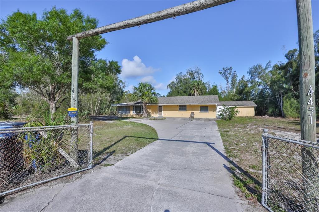 14451 Highland Road Wimauma, FL 33598 - Photo 5 of 80 a view of a pathway with a wrought fence