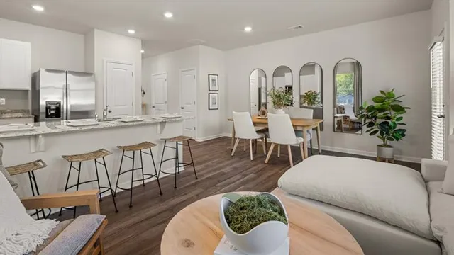 a living room with furniture a wooden floor and a chandelier