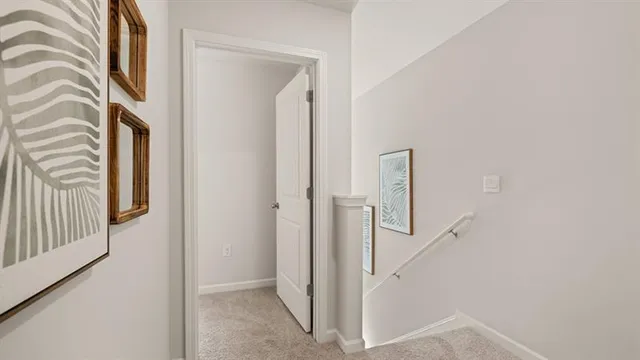 a view of a hallway with entryway and wooden floor