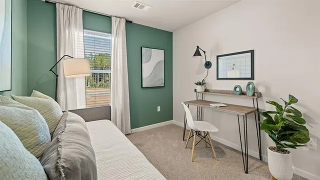 a bedroom with a large bed and a window