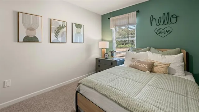 a bedroom with a bed and a painting on the wall