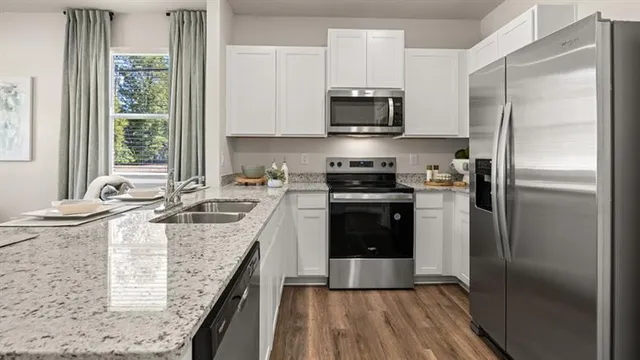 a kitchen with a sink stove and refrigerator