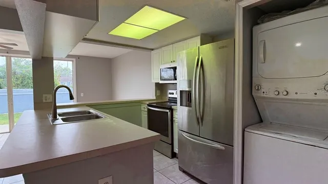 a kitchen with stainless steel appliances a stove a microwave and a refrigerator
