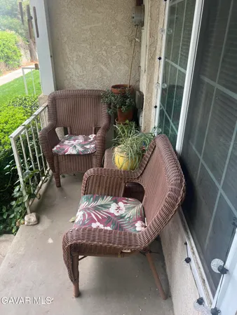 a view of balcony with furniture