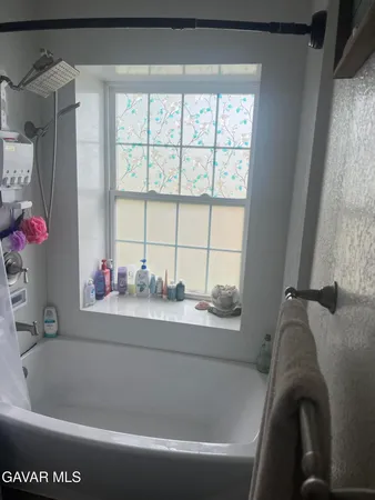 a bath tub sitting next to a window