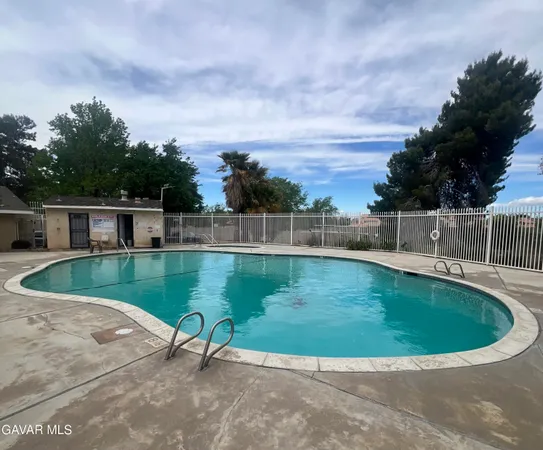 a view of a swimming pool with a yard