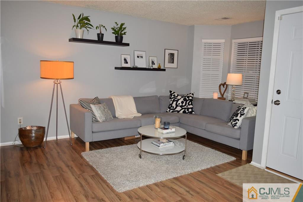 287 Nebula Road, Unit 287 Piscataway, NJ 08854 - Photo 2 of 16 a living room with furniture and a wooden floor