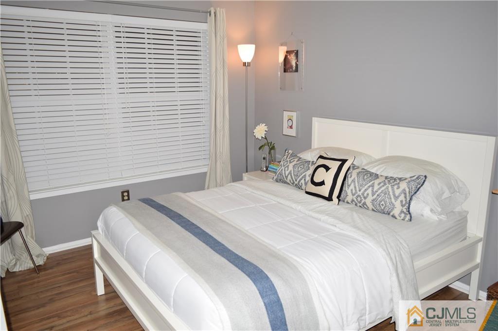 287 Nebula Road, Unit 287 Piscataway, NJ 08854 - Photo 11 of 16 a bedroom with a bed and wooden floor