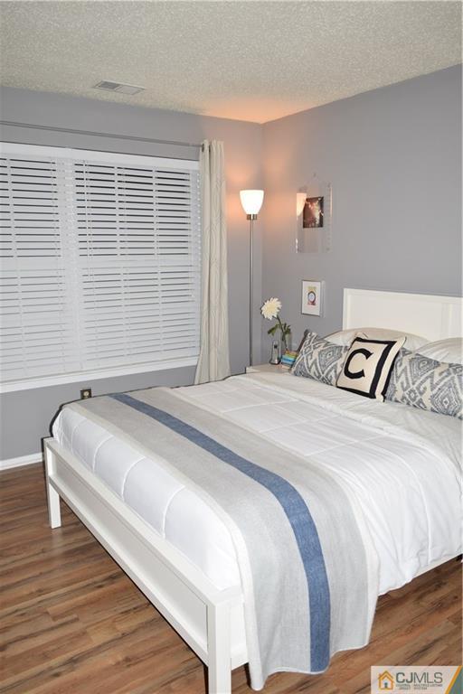 287 Nebula Road, Unit 287 Piscataway, NJ 08854 - Photo 12 of 16 a bedroom with a bed and a night stand