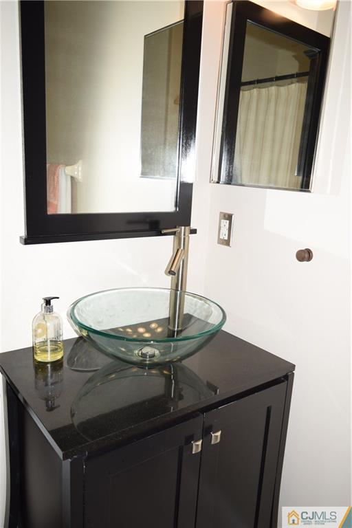 287 Nebula Road, Unit 287 Piscataway, NJ 08854 - Photo 14 of 16 a bathroom with a sink and a mirror