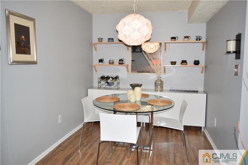 287 Nebula Road, Unit 287 Piscataway, NJ 08854 - Photo 3 of 16 a room with table and chairs