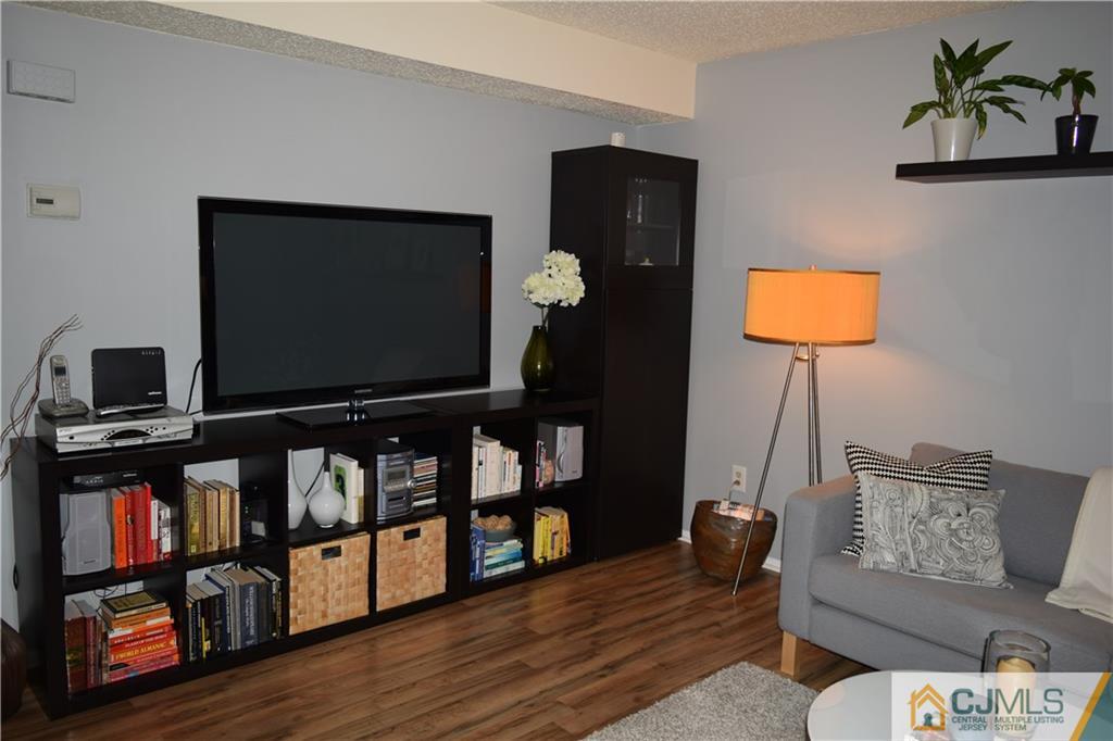 287 Nebula Road, Unit 287 Piscataway, NJ 08854 - Photo 4 of 16 a living room with furniture and a flat screen tv
