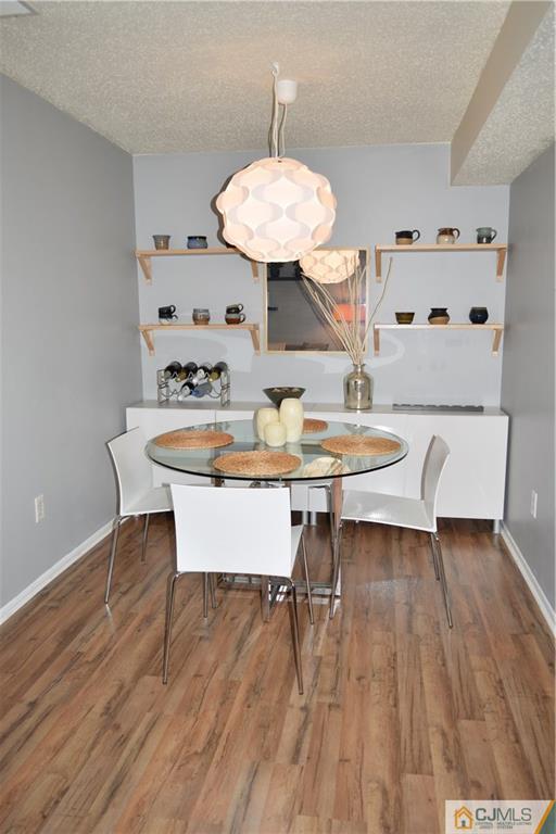 287 Nebula Road, Unit 287 Piscataway, NJ 08854 - Photo 5 of 16 a view of a dining room with furniture and wooden floor