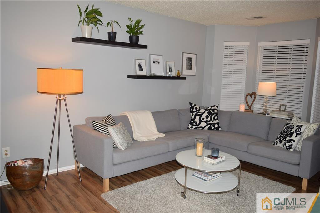 287 Nebula Road, Unit 287 Piscataway, NJ 08854 - Photo 6 of 16 a living room with furniture and a wooden floor