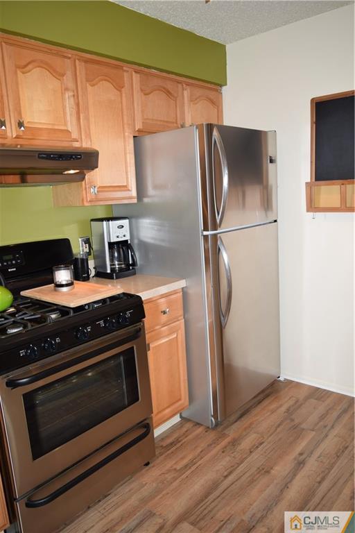 287 Nebula Road, Unit 287 Piscataway, NJ 08854 - Photo 9 of 16 a kitchen with stainless steel appliances a stove a refrigerator and a sink