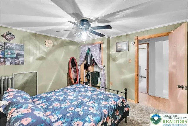 a bedroom with a bed and a mirror