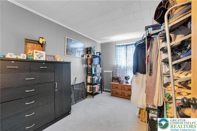 a bedroom with furniture and a window