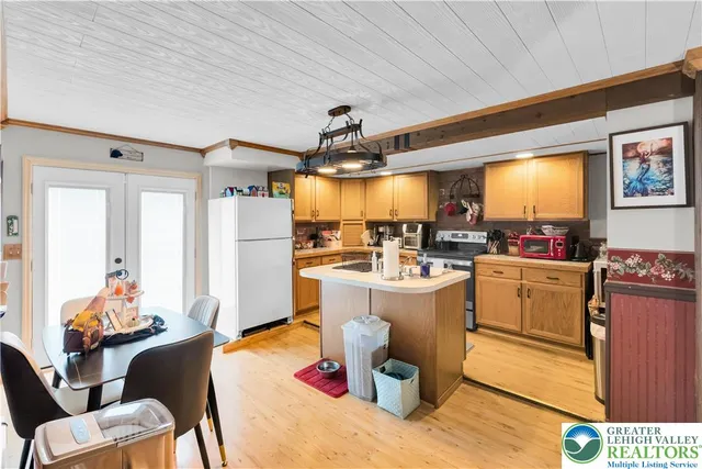 a kitchen with a refrigerator and furniture