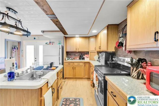 a kitchen with a sink a stove and cabinets